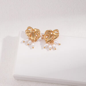 Verdant Bloom Earrings – Gold-plated monstera leaves with delicate pearl accents, inspired by nature’s beauty.