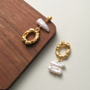 Asymmetric gold earrings with baroque pearls, artistic lines and intuitive, expressive design. Be the gliding grace. Wear Grace, Embrace Elegance.