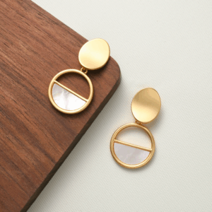 Gold and shell circle earrings with symmetrical half-moon design. Be the Gliding Grace.