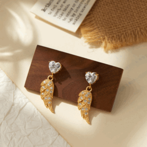 Gold heart and wing crystal earrings with vintage shine. Be the Gliding Grace.