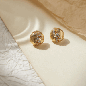 Round brushed gold earrings with a center line of micro zirconia stones. Be the gliding grace.
