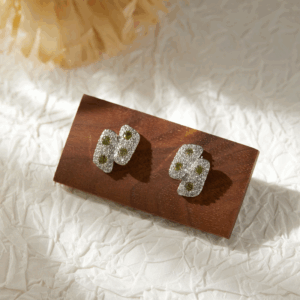 Green and gold floral drop earrings with petal layering and micro pavé zirconia detailing. Be the gliding grace.